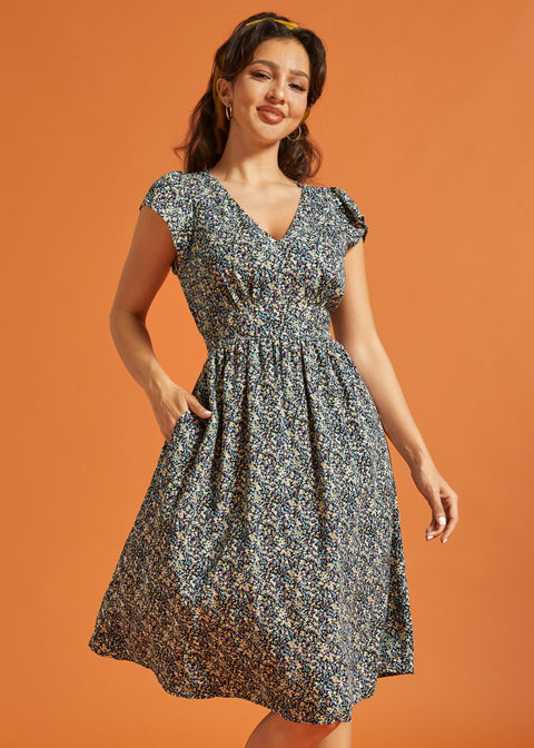 Woman wearing a black floral midi dress with V-neckline and flutter sleeves