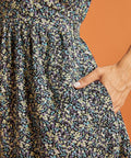 Close-up of side pocket detail on black ditsy floral dress