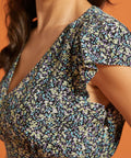 Detail of floral print and V-neck bodice on black fit-and-flare dress