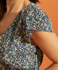 Close-up of flutter sleeve detail on black floral dress