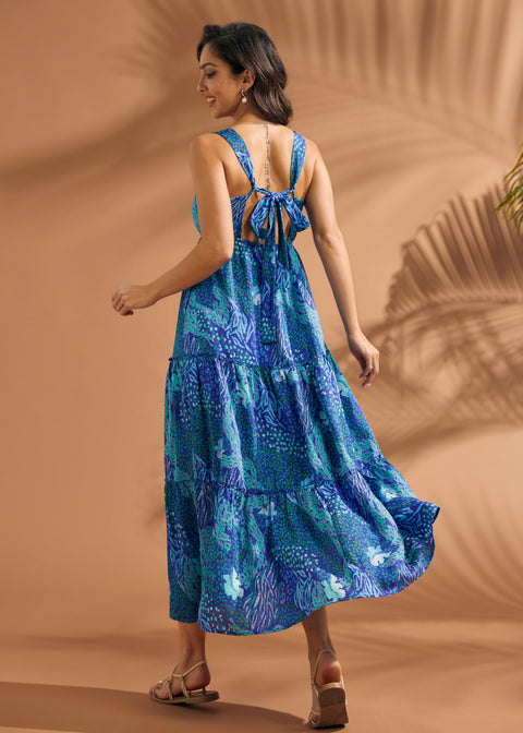 Back view of blue maxi dress featuring open-back detail and self-tie bow