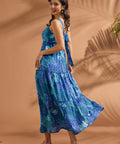 Side view of flowing blue maxi dress with tiered skirt and adjustable back tie