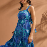 Woman wearing a breezy blue resort dress with square neckline and flowing silhouette