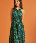 Woman wearing dark green floral halter midi dress with tie waist and button front