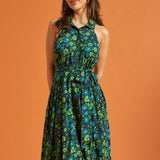 Woman wearing dark green floral halter midi dress with tie waist and button front