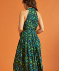 Back view of woman wearing sleeveless green floral midi dress