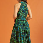 Back view of woman wearing sleeveless green floral midi dress