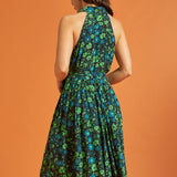 Back view of woman wearing sleeveless green floral midi dress