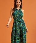 Woman wearing retro floral midi dress with sleeveless halter neckline
