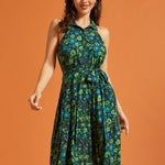 Woman wearing retro floral midi dress with sleeveless halter neckline