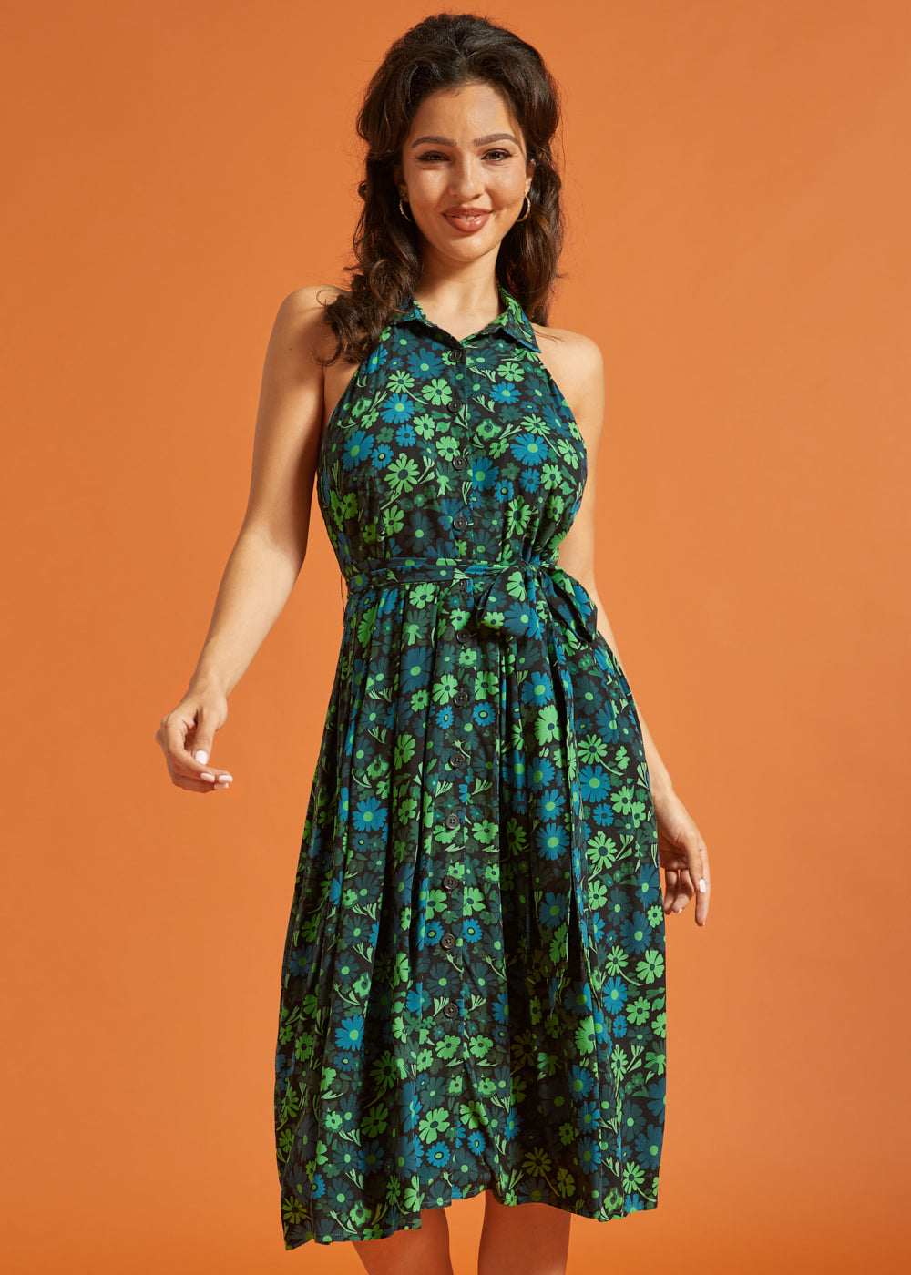 Woman wearing retro floral midi dress with sleeveless halter neckline