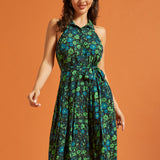 Woman wearing retro floral midi dress with sleeveless halter neckline