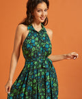 Woman wearing 60's vintage-inspired floral dress with fabric belt