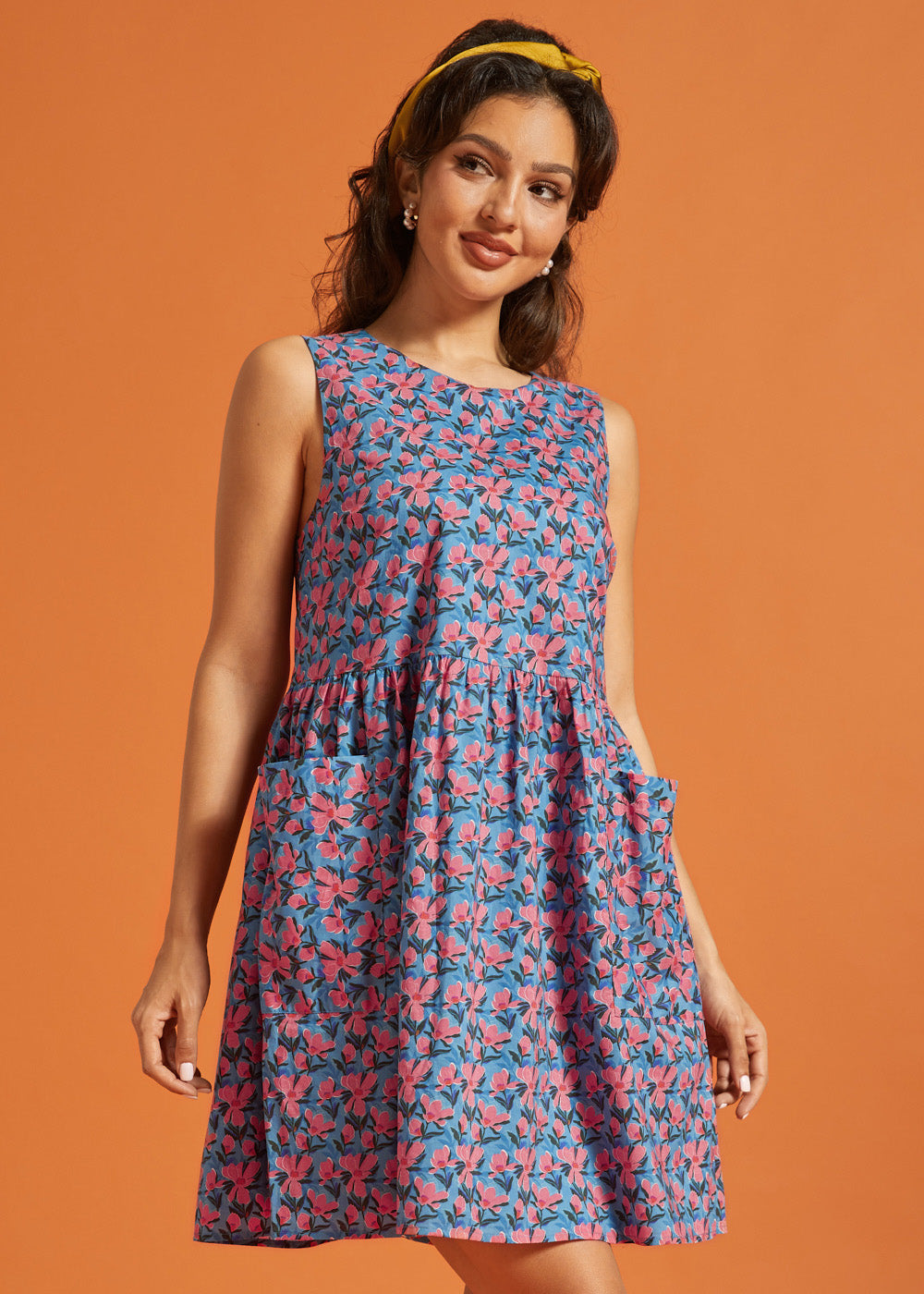 Side view of the sleeveless cotton floral dress with gathered drop waist.