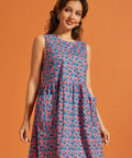Side view of the sleeveless cotton floral dress with gathered drop waist.