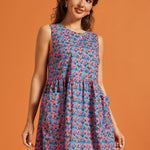 Side view of the sleeveless cotton floral dress with gathered drop waist.