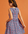 Back view of the blue floral A-line dress featuring a keyhole button closure.