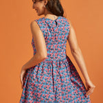 Back view of the blue floral A-line dress featuring a keyhole button closure.