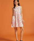 Woman wearing a vintage-inspired pink fruit print mini dress with pockets
