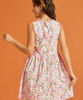 Woman wearing a floral dress against an orange background