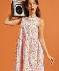 Woman wearing a pink lemon print cotton dress while carrying a retro boombox