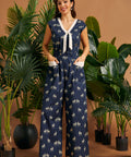 Full-length view of a cotton stretch zebra print jumpsuit with contrast trim, wide legs, and oversized patch pockets.