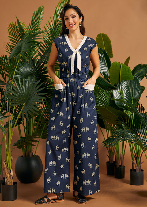 Full-length view of a cotton stretch zebra print jumpsuit with contrast trim, wide legs, and oversized patch pockets.