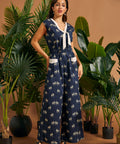 Woman wearing a vintage-inspired zebra print jumpsuit with wide legs and contrast pocket trim.
