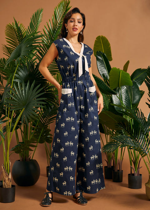 Woman wearing a vintage-inspired zebra print jumpsuit with wide legs and contrast pocket trim.