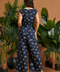 Back view of a navy zebra print one-piece featuring an elastic waist and flowing wide-leg silhouette.