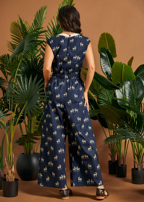Back view of a navy zebra print one-piece featuring an elastic waist and flowing wide-leg silhouette.