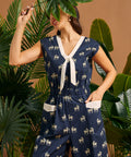 Woman wearing a navy blue nautical style jumpsuit with quirky zebra print.