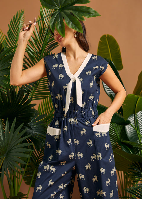 Woman wearing a navy blue nautical style jumpsuit with quirky zebra print.