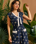Side view of a navy safari-inspired jumpsuit with zebra print, tie neckline, and elastic waist.