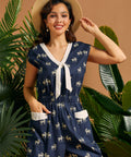 Woman wearing a retro wide-leg zebra print jumpsuit with front patch pockets and cap sleeves.