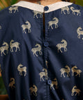 Back detail showing the button closure and zebra print on the navy jumpsuit.