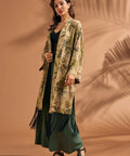 Woman wearing tropical leopard print fringe duster over green wide leg pants.