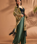 Woman styling tropical print duster with flowing silhouette and black fringe hem.