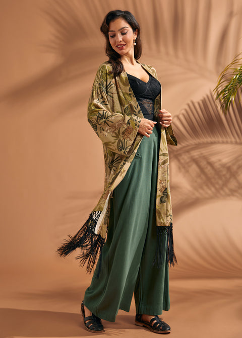 Woman styling tropical print duster with flowing silhouette and black fringe hem.