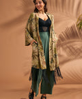 Woman wearing tropical foliage fringe duster with relaxed wide sleeves.