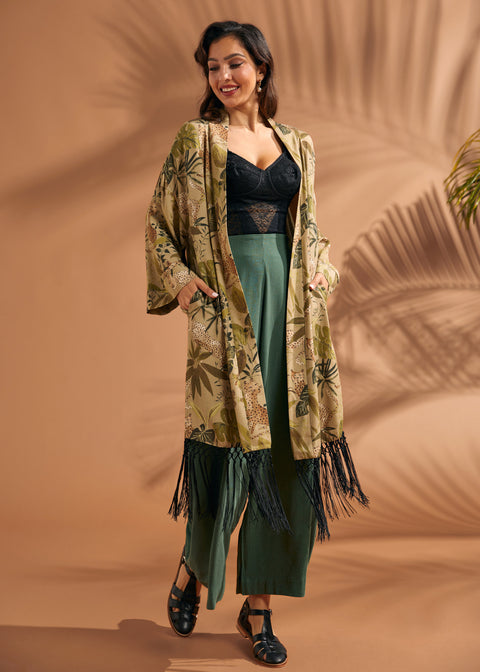 Woman wearing tropical foliage fringe duster with relaxed wide sleeves.