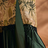 Close-up of black fringe trim and side slit on tropical print duster.
