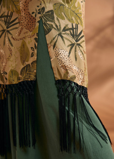 Close-up of black fringe trim and side slit on tropical print duster.