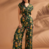 Woman wearing vintage-inspired tropical tiki print wide leg pants with matching top.