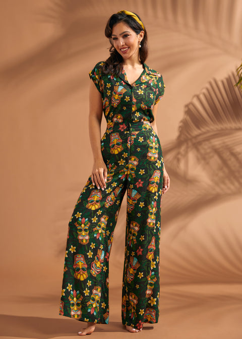 Woman wearing vintage-inspired tropical tiki print wide leg pants with matching top.