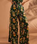 Front view of black tiki print linen blend wide leg pants with pockets.