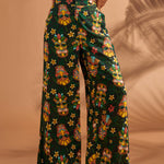 Front view of black tiki print linen blend wide leg pants with pockets.