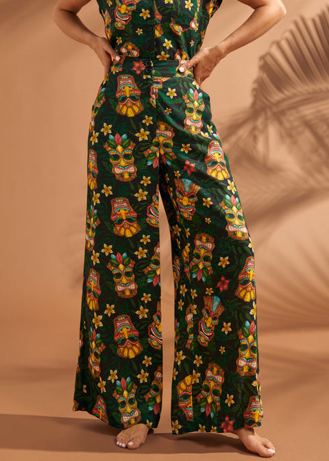 Front view of black tiki print linen blend wide leg pants with pockets.