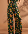 Full-length view of black tropical floral and tiki print pants with high-rise waist.