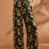 Full-length view of black tropical floral and tiki print pants with high-rise waist.